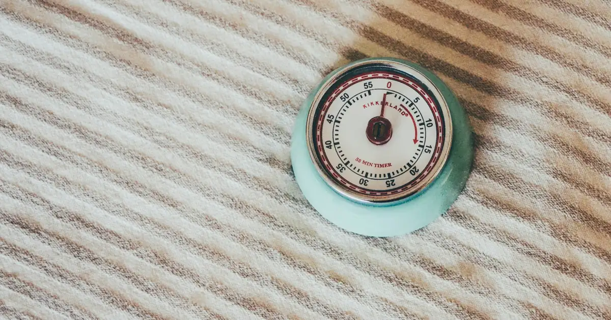 Kitchen timer symbolizing slower gut transit time during perimenopause hormone changes.